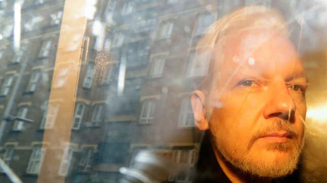 Buildings are reflected in the window as WikiLeaks founder Julian Assange is taken from court, where he appeared on charges of jumping British bail seven years ago, in London, Wednesday May 1, 2019.