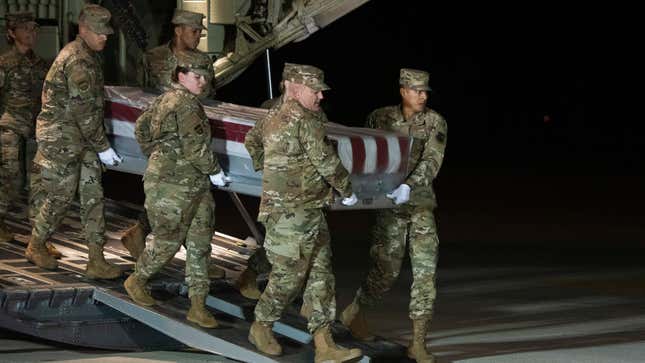 An Air Force carry team moves the transfer case containing the remains of Navy Seaman Apprentice Cameron Scott Walters on Dec. 8, 2019, at Dover Air Force Base. A Saudi gunman killed three people including Walters in a shooting at Naval Air Station Pensacola in Florida. 