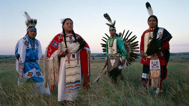 Lakota men and women in traditional costume outside Rosebud, South Dakota