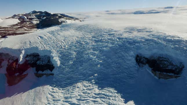 A glacier creeps down a valley on the edge of the Ross Sea near McMurdo Station in Antarctica.
