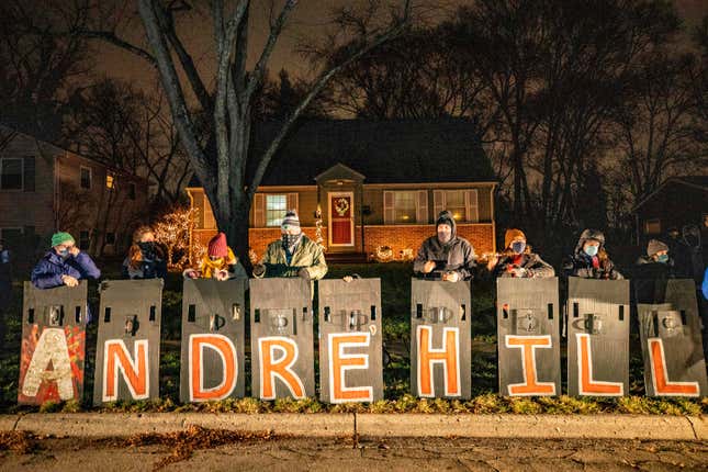 People hold shields spelling Andre Hill’s name as they participate in a call to action “White People Stop Calling the Cops on Black People” protest hosted by Showing Up for Racial Justice Columbus(SURJ) in front of the house of the neighbor who called the police on Andre Hill the night he was shot and killed in Columbus, Ohio on December 28, 2020.