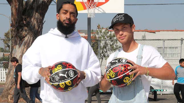 Nipsey Hussle and artist/painter Drew Visuals attend Nipsey Hussle x Puma Hoops Basketball Court Refurbishment Reveal Event on Oct. 22, 2018, in Los Angeles.