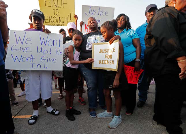 Kiwanda Robinson, center, mother of Keeven Robinson, holds family friends Madysen Johnson, right, and her sister Morgan Johnson, at the start of a solidarity march for Keeven in Jefferson Parish, La., Monday, May 14, 2018.