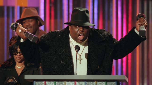Notorious B.I.G., who won rap artist and rap single of the year, clutches his awards at the podium during the Billboard Music Awards in New York, on evening, Dec. 6, 1995.