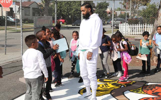 Nipsey Hussle greets kids at the Nipsey Hussle x PUMA Hoops Basketball Court Refurbishment Reveal Event on October 22, 2018 in Los Angeles, California.