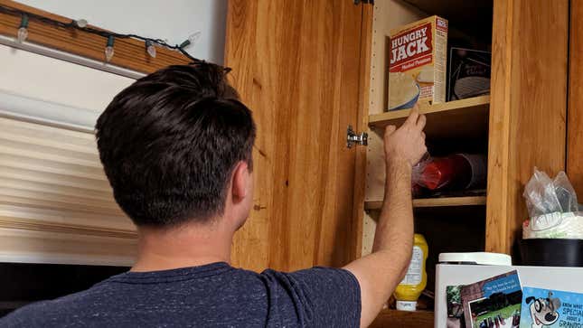 Image for article titled Dwindling Kitchen Resources Forcing Man To Scavenge For Food Higher And Higher In Cabinets