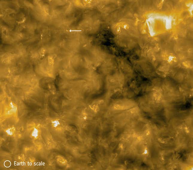 A campfire (indicated by white arrow), with Earth scale at bottom left.