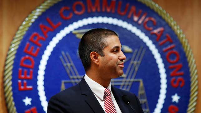 After a meeting voting to end net neutrality, Federal Communications Commission (FCC) Chairman Ajit Pai smiles while listening to a question from a reporter in Washington.