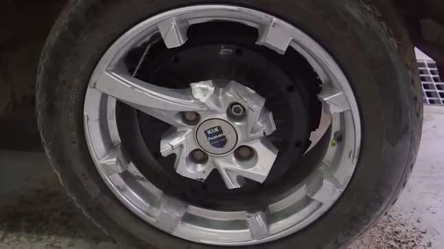 Watch A Man Try To Drive A Car On Wheels With Only A Single Spoke
