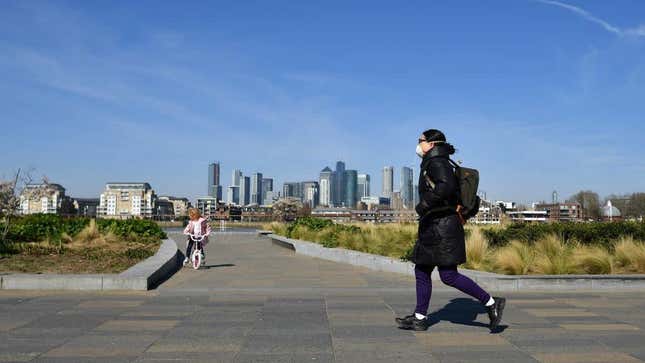 A woman walks in Greenwich, south east of London, on March 24, 2020 after Britain’s government ordered a lockdown to slow the spread of the novel coronavirus. 