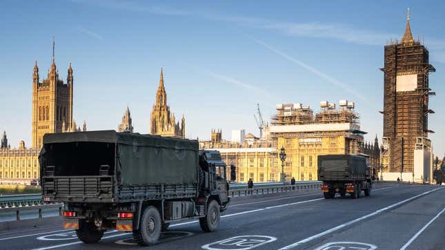 Military vehicles cross Westminster Bridge on March 24, 2020 in London, England.
