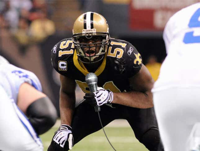 Image for article titled Budget Cuts Force CBS To &quot;Mic Up&quot; Jonathan Vilma With Handheld Microphone