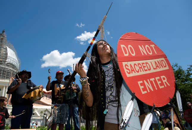 An Apache activist dancer performs in a rally to save the Oak Flat area, in front of the U.S. Capitol.