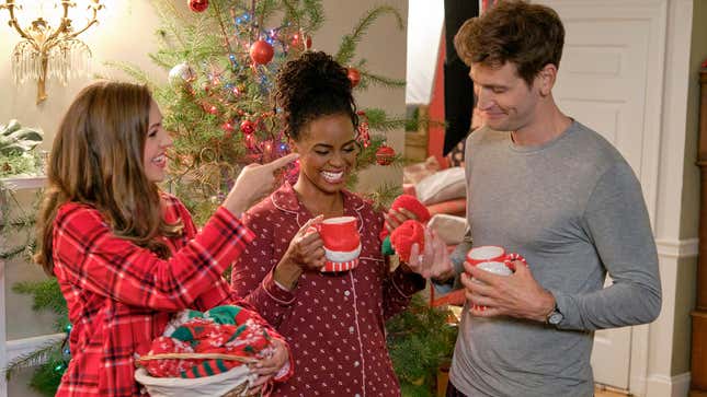 Three people celebrate Christmas morning in a Hallmark movie