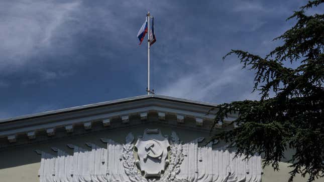 Russian flag and flag of Crimea over the city council of Yalta on August 11, 2015 in Yalta, Crimea. Russian President Vladimir Putin signed a bill in March 2014 to annex the Crimean peninsula but Ukraine and most of the international community do not recognize its annexation.