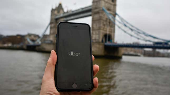 File photo illustration showing the Uber logo on a phone in front of Tower Bridge in London, England. 
