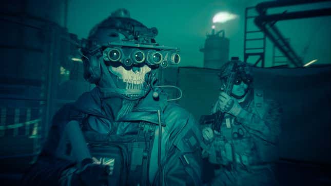 Soldiers equipped with night vision walk through a battlefield.