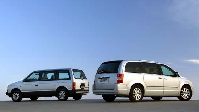 A photo of two Chrysler Voyager minivans parked side by side. 