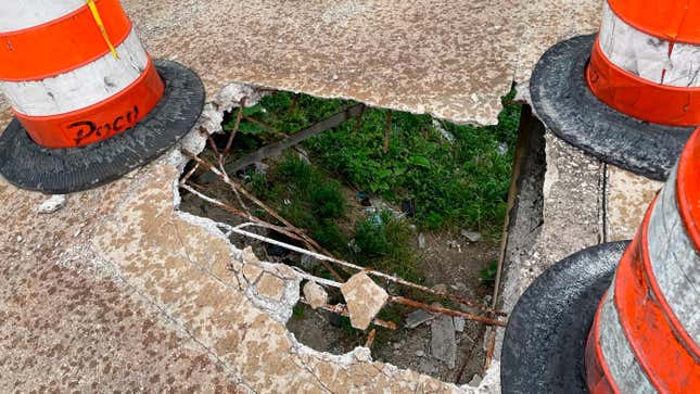 The ground below an elevated pedestrian bridge spanning the M-10 Lodge freeway in Detroit is visible through a hole in the concrete, large enough for a person to fall through. Ely Hydes was walking the footbridge to a Detroit Tigers game when the concrete collapsed on May 9, 2022. He says he fell 15 feet to the ground below. The bridge stayed open for days until The Detroit News contacted the state Transportation Department on Sunday, May 15. 