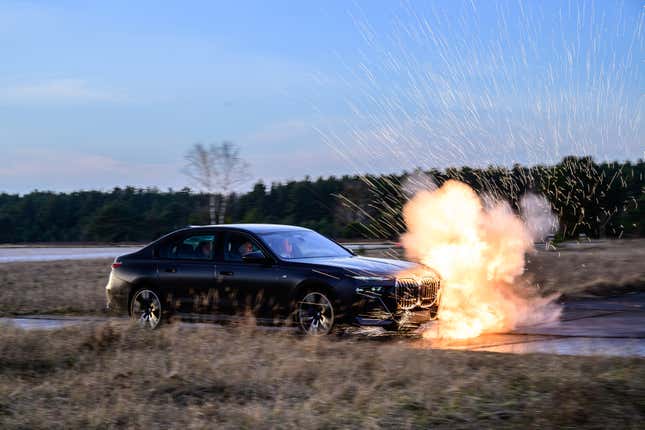 Front 3/4 view of an armored BMW 7 Series avoiding an explosion