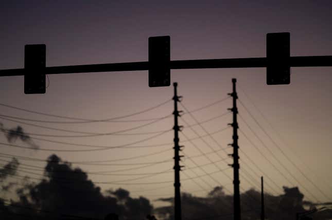 FILE - Traffic lights are out of service during a blackout in San Juan, Puerto Rico, early April 7, 2022. As Puerto Rico struggles with chronic power outages and a decaying electric grid, officials believe the U.S. territory that is heavily dependent on fossil fuels can fully shift to clean energy by 2050, according to a new study by FEMA and the US Dept. of Energy published on Feb. 7, 2024. (AP Photo/Carlos Giusti, File)