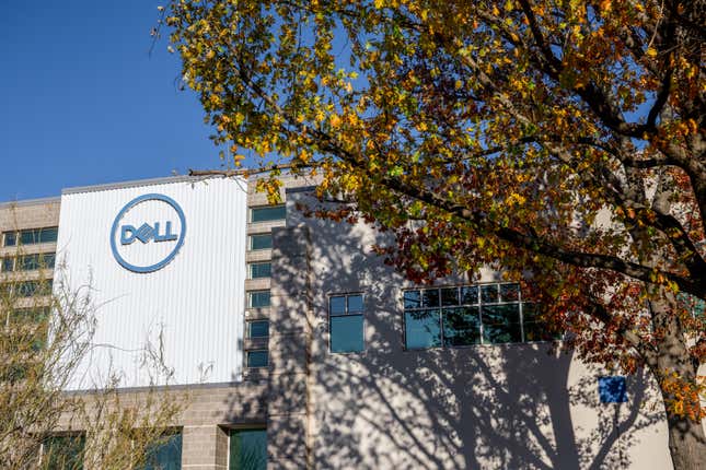 dell logo on a building obscured with trees
