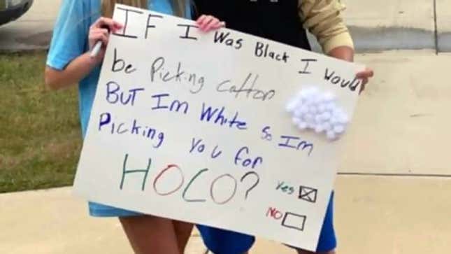 Image for article titled Viral Photo Shows White Kansas High Schoolers Posing with Racist Homecoming Proposal Sign