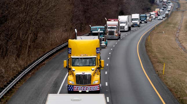 Participants of the Peoples Convoy drive the beltway around Washington, DC, near Cabin John, Maryland on March 6, 2022. - Hundreds of truckers and their supporters in the convoy set off from southern California to Washington to protest against Covid-19 pandemic restrictions. 