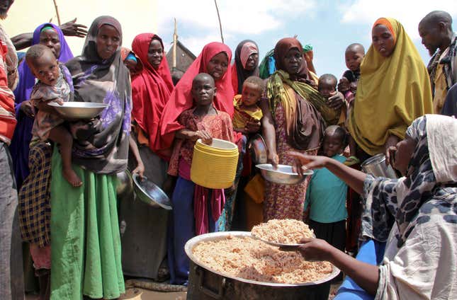 FILE - Newly arrived Somalis, displaced by a drought, receive food distributions at makeshift camps in the Tabelaha area on the outskirts of Mogadishu, Somalia on March 30, 2017. The United Nations says at least three of every four Africans can’t afford a healthy diet because of an “unprecedented food crisis.” A U.N. report released Thursday, Dec. 7, 2023 with the African Union Commission says rising hunger and malnutrition in the continent of 1.4 billion people is caused by conflicts, climate change and the aftereffects of the pandemic. (AP Photo/Farah Abdi Warsameh, File)