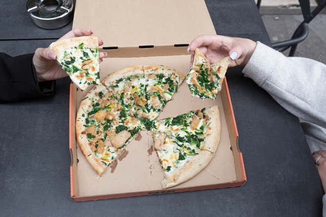 Customers eat a robot-made pizza at Pazzi, Paris’ first robotic pizzeria, on July 9, 2021 in Paris, France. 