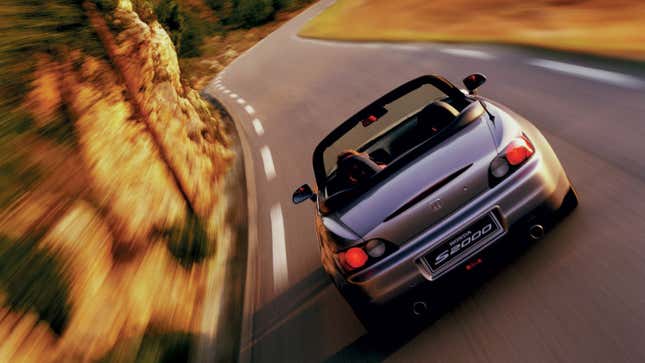 Silver Honda S2000 on road rear view