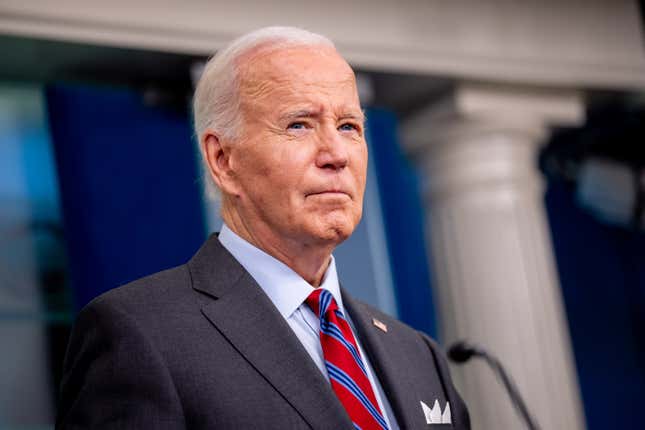 close up of Joe Biden standing at a podium with a straight face