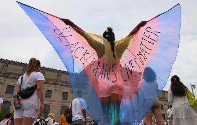 NEW YORK, NEW YORK - JUNE 13: A person spreads wings with the words “Black Trans Lives Matter” written on them during the Brooklyn Liberation’s Protect Trans Youth event at the Brooklyn Museum on June 13, 2021 in the Brooklyn borough in New York City. Brooklyn Liberation organized a march and rally as an emergency action response to legislation to restrict trans rights across 34 states. According to the Human Rights Campaign, there have been over 250 bills introduced in state legislatures aimed at the LGBTQ community in 2021.