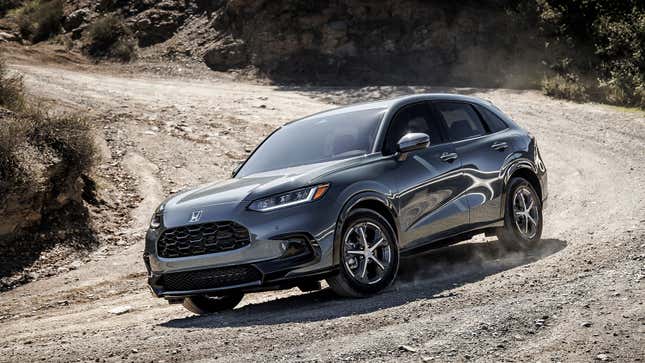 A photo of a grey 2023 Honda HR-V SUV on gravel. 