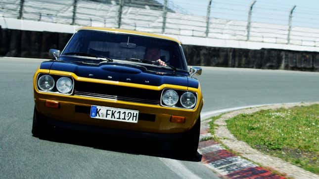 A photo of a yellow Ford Capri driving on a track. 