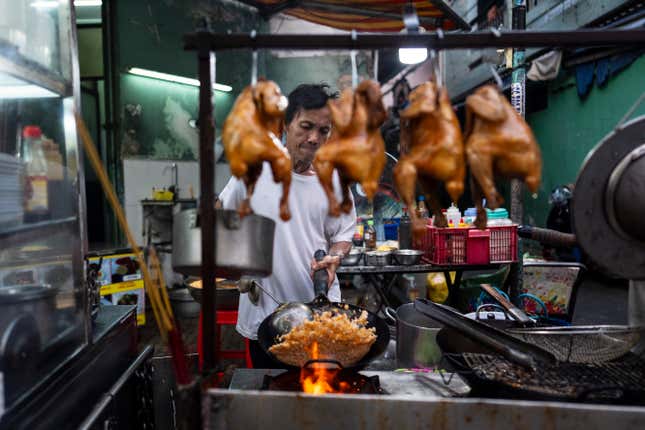 Restaurant owner Hien Ky prepares fried rice in Ho Chi Minh City, Vietnam, Saturday, Jan. 27, 2024. Vietnam is the world&#39;s third largest rice exporter, and the staple importance to Vietnamese culture is palpable in the Mekong Delta. (AP Photo/Jae C. Hong)