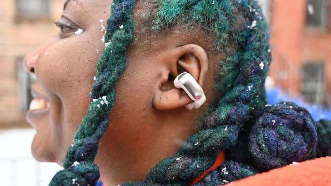 A photo of a person wearing the Bose Ultra Open Earbuds