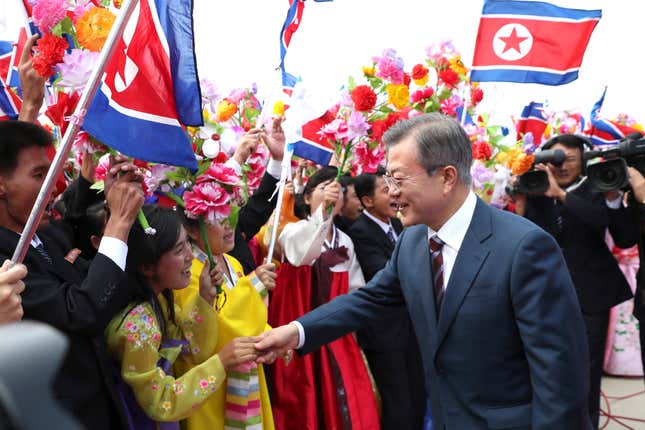 South Korean president Moon Jae-in, right, is greeted by North Korean people during a welcome ceremony at the Sunan International Airport in Pyongyang.