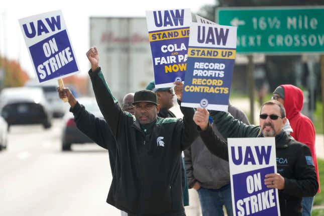 FILE - United Auto Workers members walk the picket line during a strike at the Stellantis Sterling Heights Assembly Plant, in Sterling Heights, Mich., Monday, Oct. 23, 2023. A six-week United Auto Workers strike at Ford cut sales by about 100,000 vehicles and cost the company $1.7 billion in lost profits this year, Ford said Thursday, Nov. 30, 2023. (AP Photo/Paul Sancya, File)