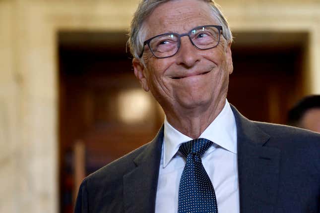 close up of Bill Gates grinning and looking upwards