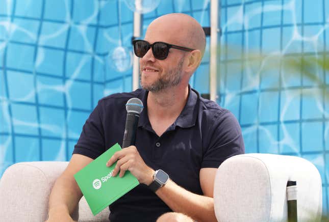 Spotify CEO Daniel Ek wears sunglasses and speaks into a microphone.