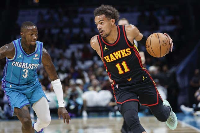 Oct 25, 2023; Charlotte, North Carolina, USA;  Atlanta Hawks guard Trae Young (11) drives around Charlotte Hornets guard Terry Rozier (3) during the first quarter at Spectrum Center.