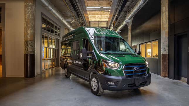 A photo of a green Ford E-Transit electric van. 