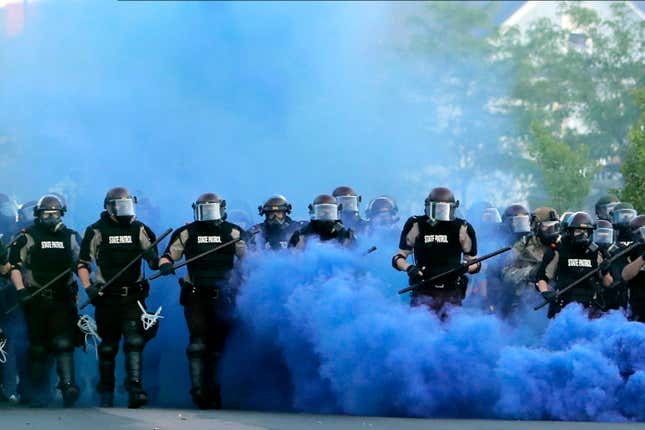  In this May 30, 2020, file photo, Minnesota State Police officers approach a crowd of protesters in Minneapolis. The Minnesota State Patrol purged e-mails and texts messages immediately after their response to protests in the wake of George Floyd’s death last summer, according to court testimony in a lawsuit that alleges the State Patrol targeted journalists during the unrest. 