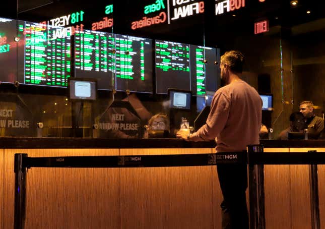 FILE - A customer makes a sports bet at the Borgata casino in Atlantic City N.J. on March 17, 2022 just before the March Madness NCAA college basketball tournament began. As March Madness gets underway, more people than ever now can legally bet on sports. A total of 38 states and the District of Columbia now allow some form of sports betting. (AP Photo/Wayne Parry, File)