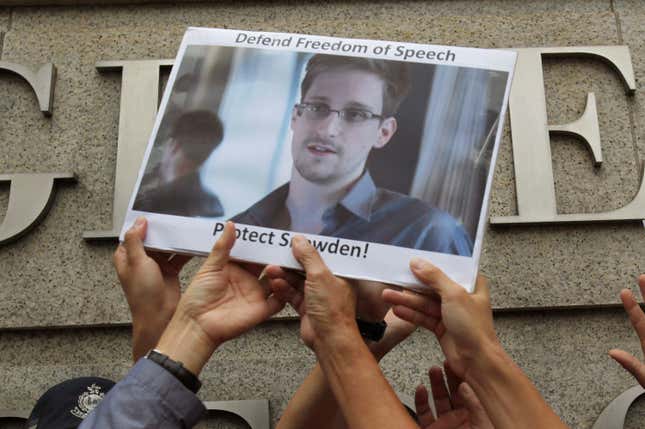 Protesters hold a photo of Edward Snowden outside the US Consulate in Hong Kong in 2013