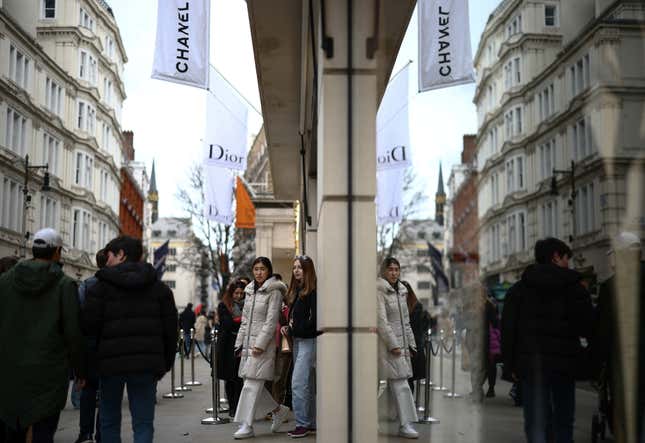 People walk outside a Chanel store on New Bond Street in London, Britain, March 11, 2023.