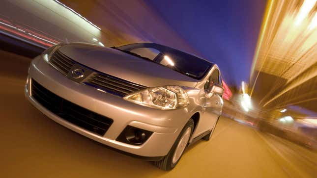 A photo of a silver Nissan Versa sedan. 