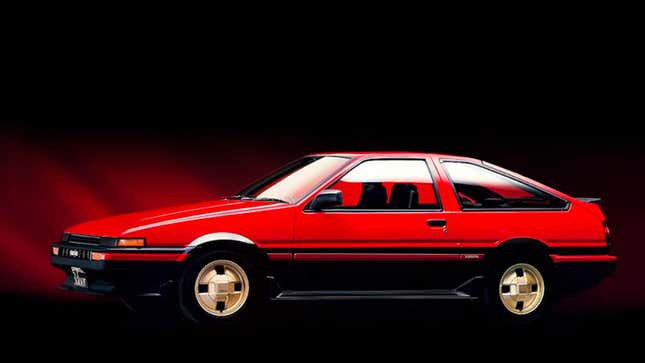 A photo of a red Toyota coupe in a studio. 