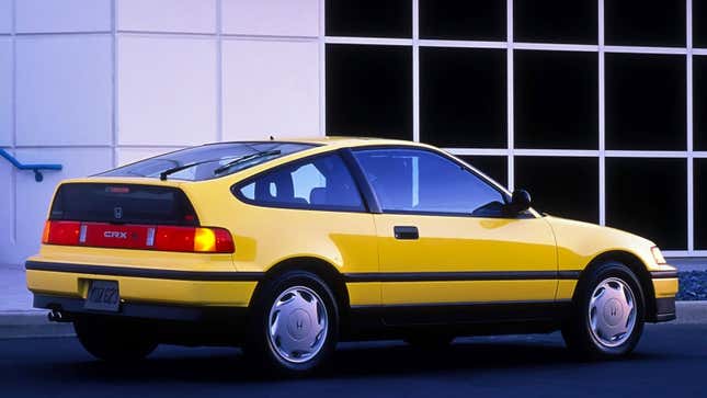 A photo of a yellow Honda CRX sports car. 